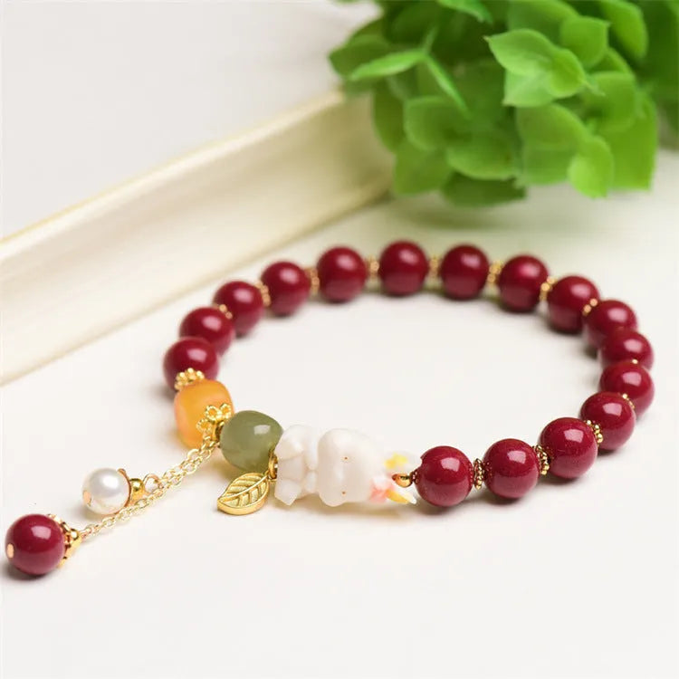 Natural Tian Yu cinnabar bracelet in purple gold sand colour with rabbit design, shown in 8mm and 10mm width options