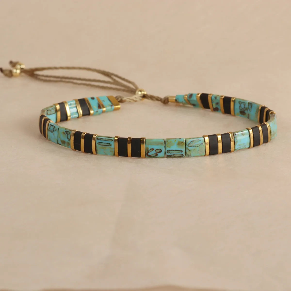 Geometric glass beads bracelet in five colour options showing 8mm beads and secure clasp on wrist