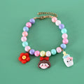 Macaron-coloured resin pet collar with adjustable sizing on a small dog, showing glossy finish and bracelet accessory.