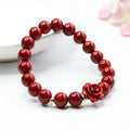Purple gold sandstone cinnabar bracelet with 8mm rose-carved beads on wrist