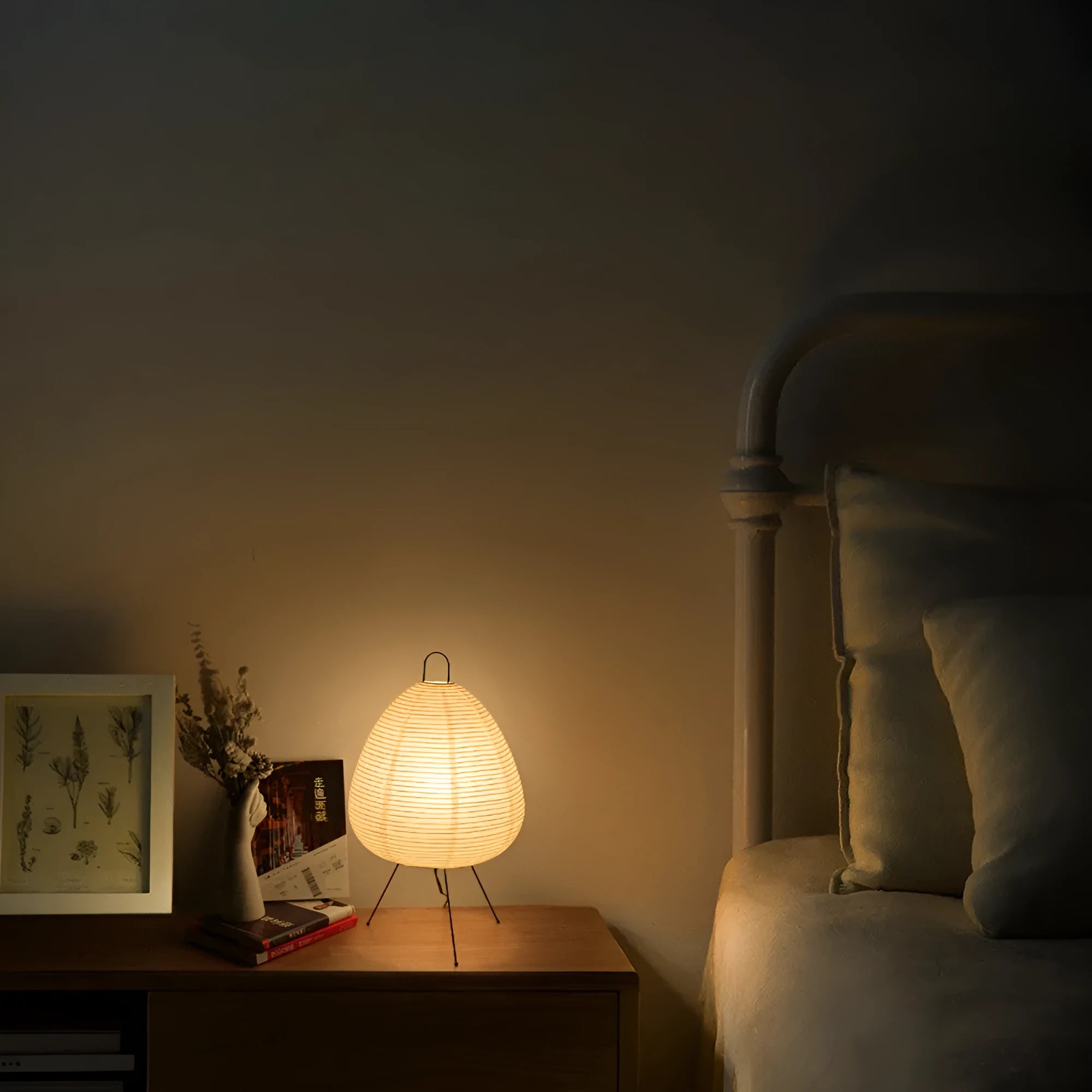 Japanese style rice paper table lamp with aluminium base on a wooden surface.