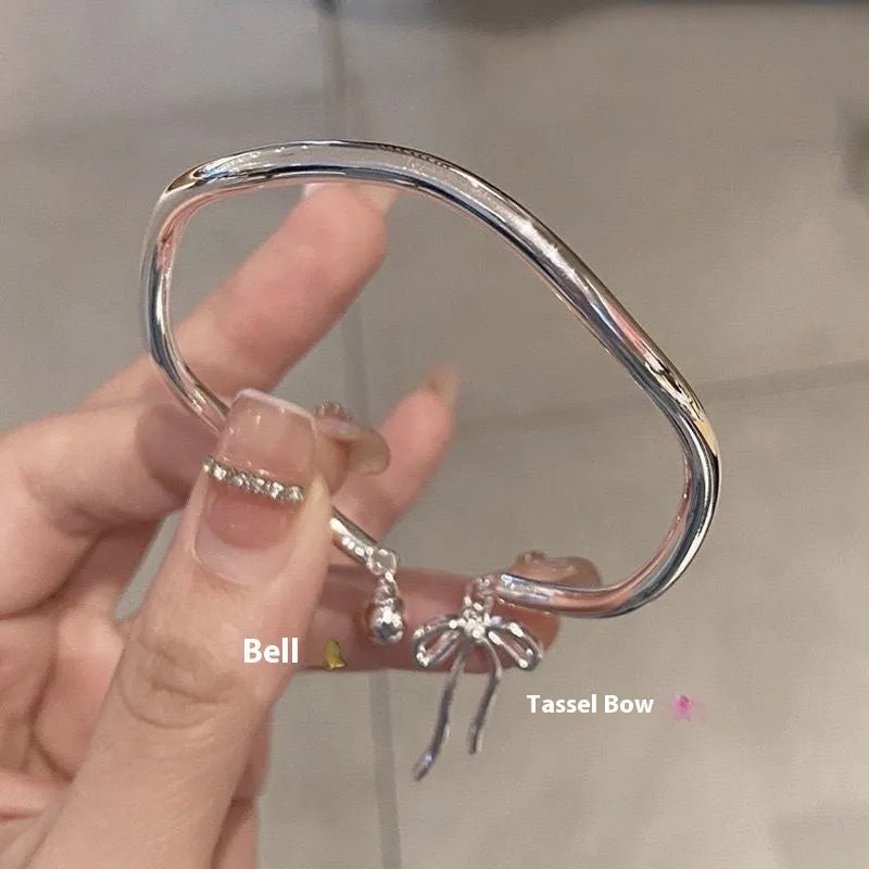 Silver adjustable bow bracelet with zinc alloy construction and electroplated finish on wrist