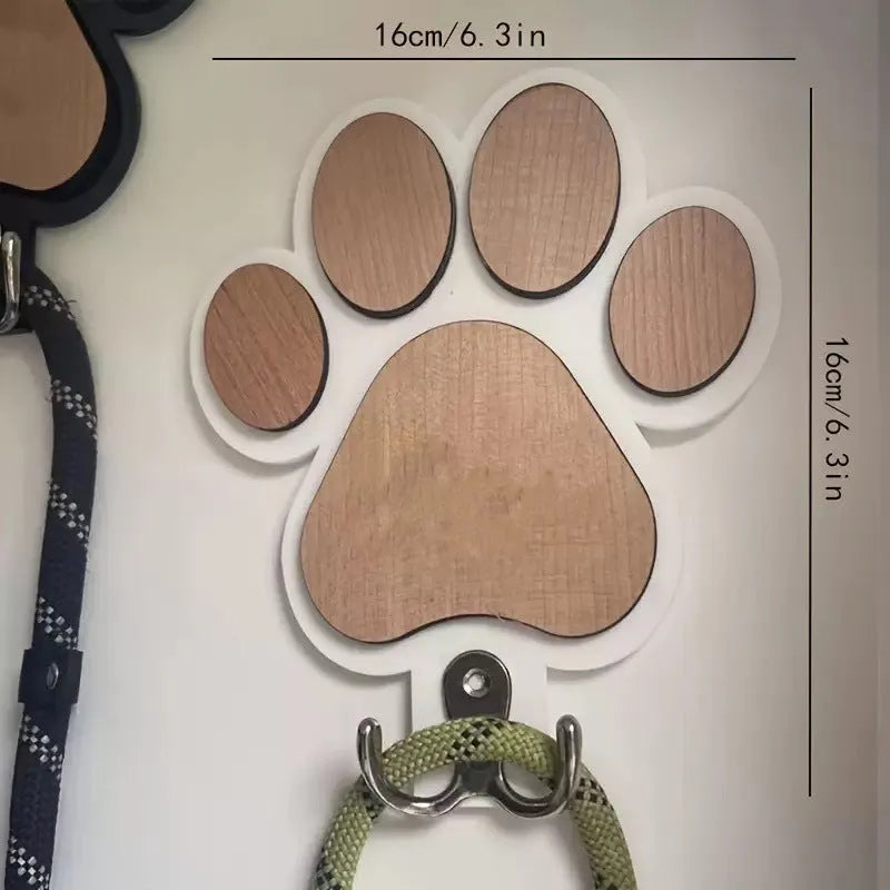 Black wooden wall hook shaped like a paw print for hanging coats and keys