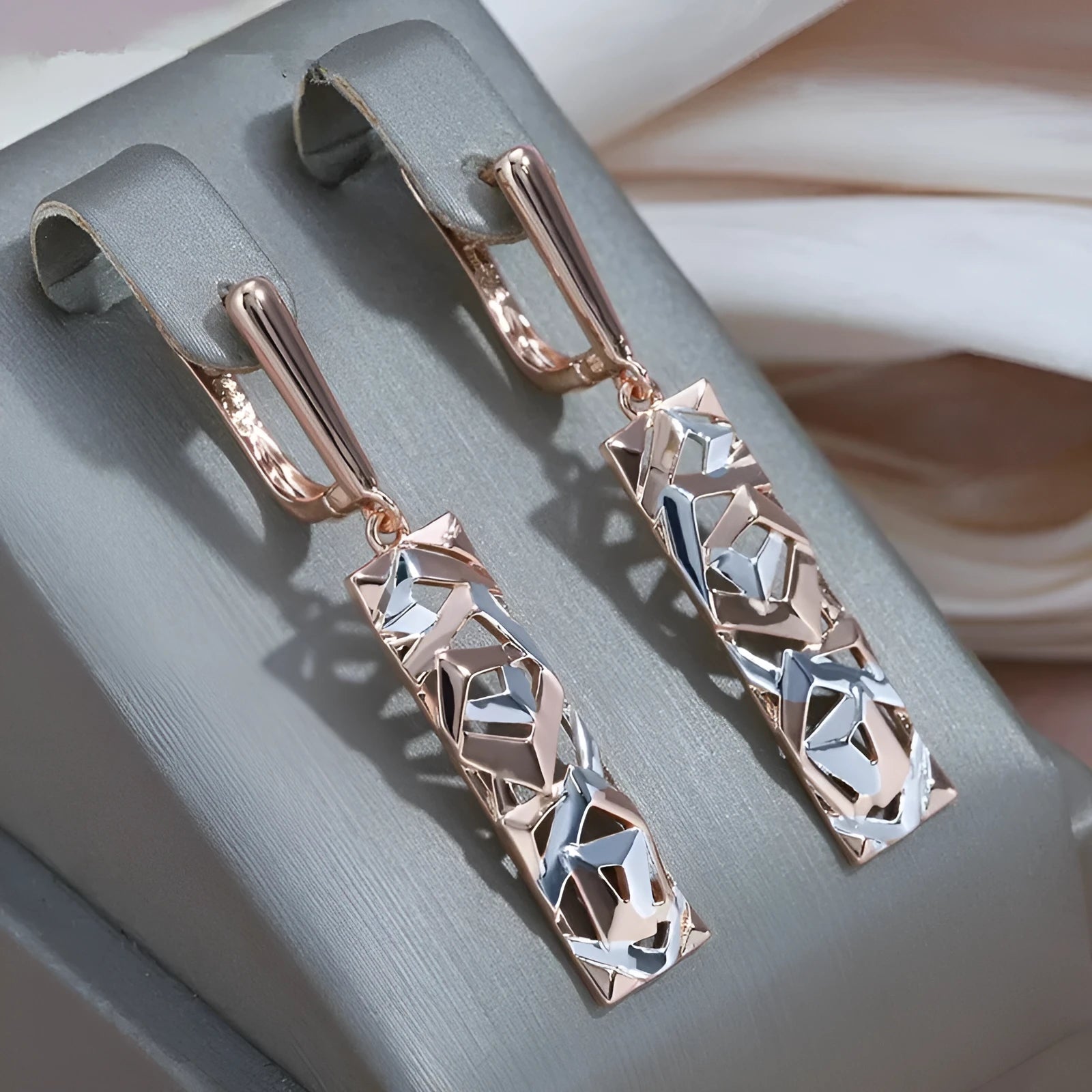 Rectangular two-tone hollow stud earrings for women with a geometric electroplated alloy design.