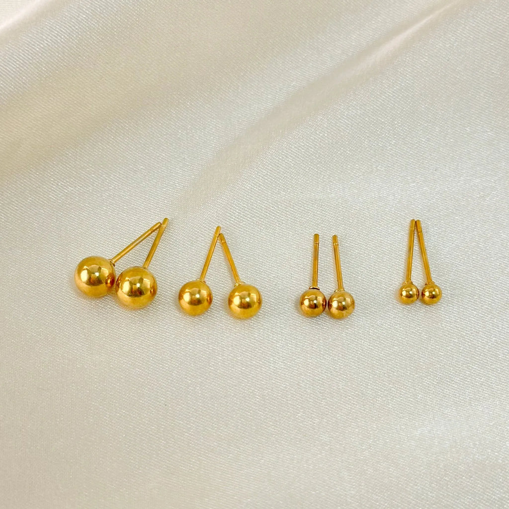Stainless steel ball stud earrings with round geometric design in gold or silver finish, showing front and side views