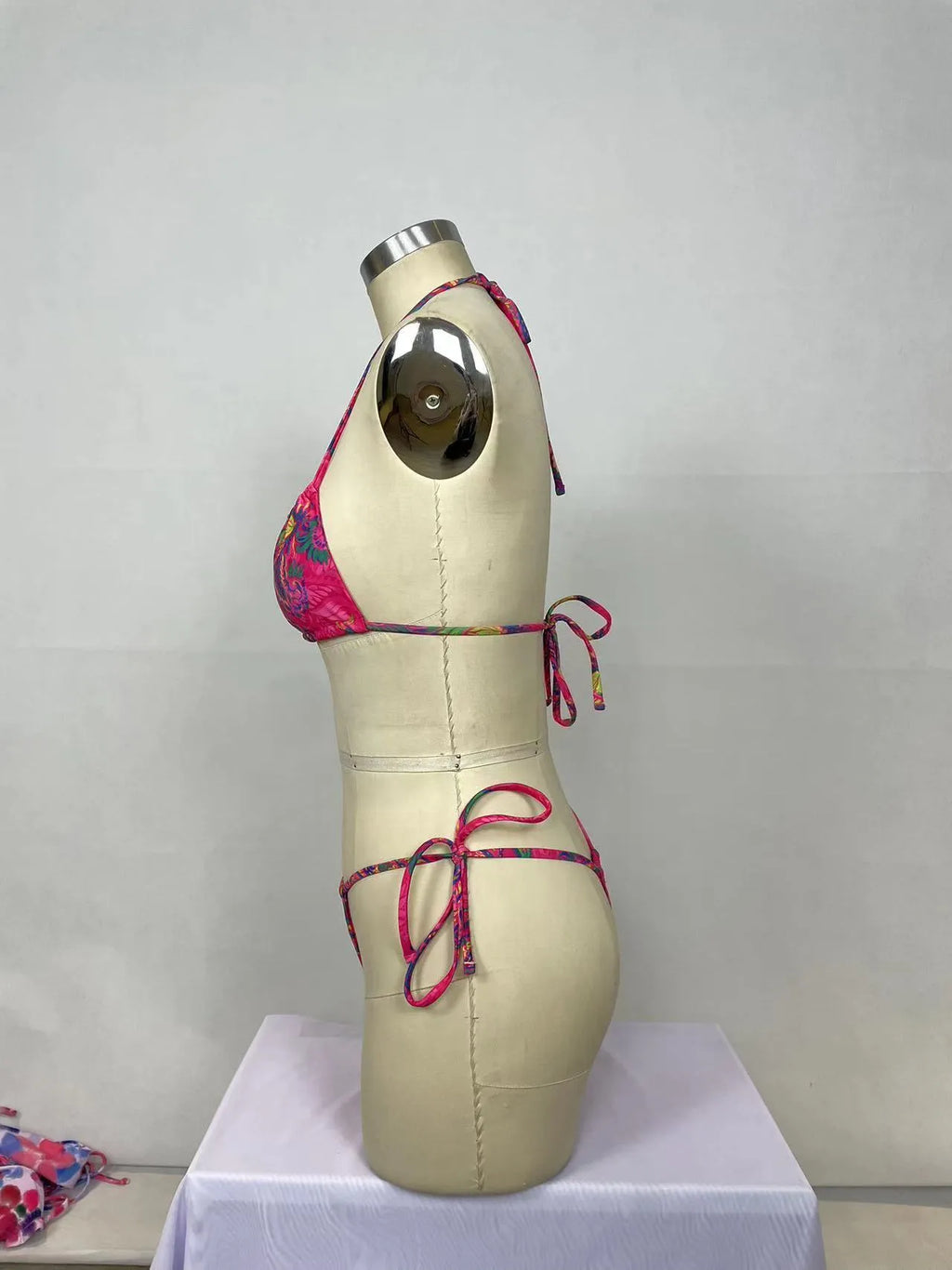 Pink printed women's bikini two-piece set with brief triangle style, shown from front.