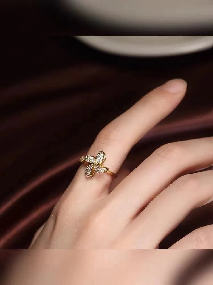 Micro inlaid rotating ring with spinning windmill design in gold or silver electroplated finish on copper