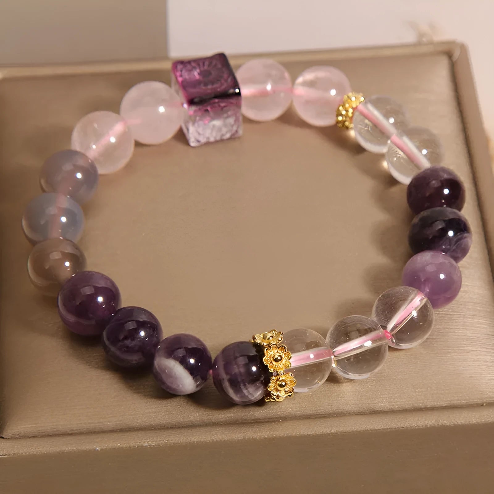 Women's purple amethyst crystal bracelet with rhinestone accents showing 10mm stones