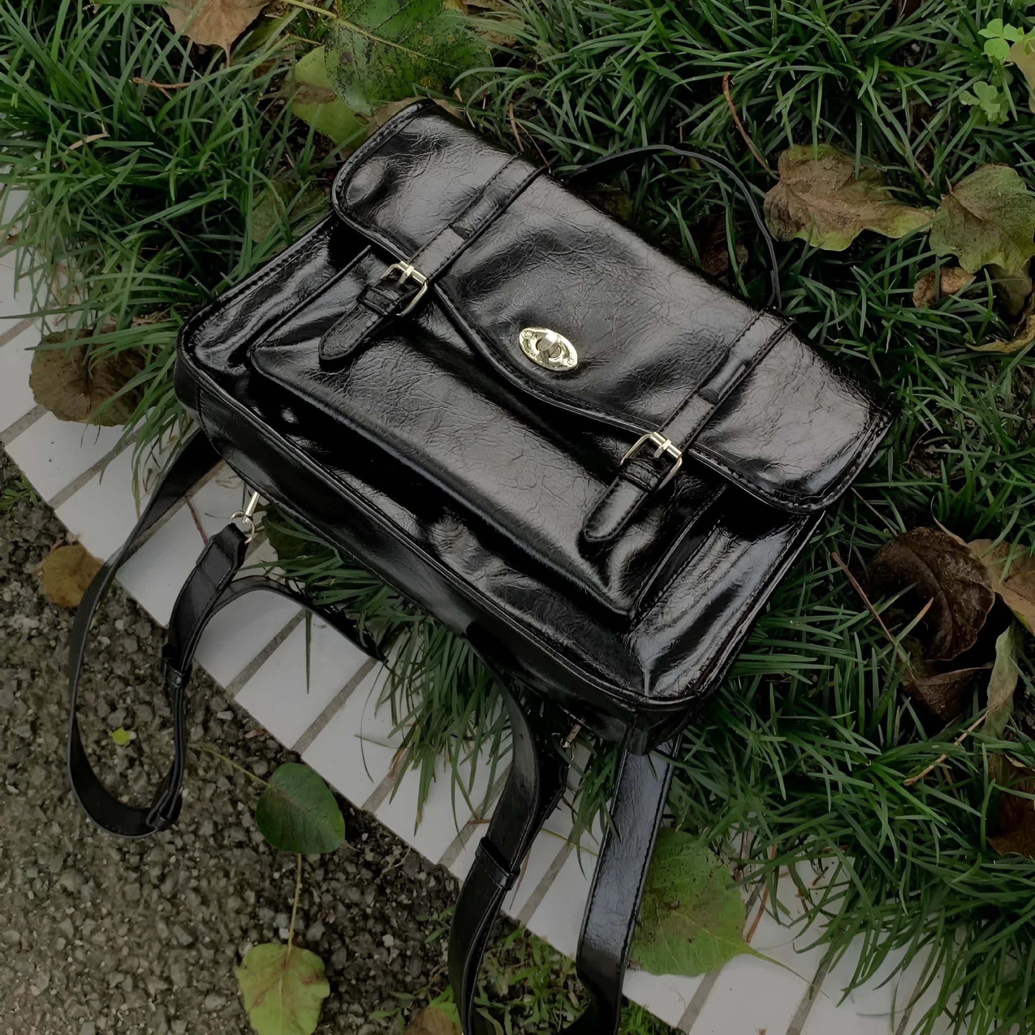Black college messenger bag with oil wax PU leather finish showing satchel silhouette