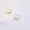Geometric horse eye ring with tricolour zircon stones on a 14k gold-plated copper band.