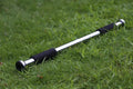 Steel adjustable pull-up bar extended across a door frame for home fitness training