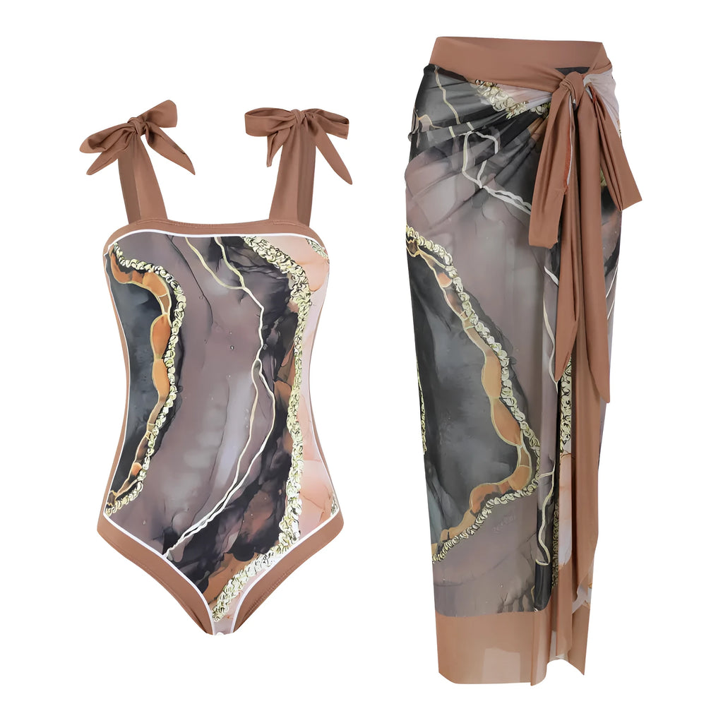 Floral print one-piece swimsuit with mesh tube top and a matching detachable skirt laid flat.