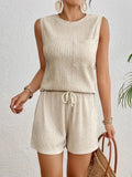 Solid colour sleeveless round neck vest and shorts set in apricot or orange, made from 100% polyester with S to XXL sizing options.