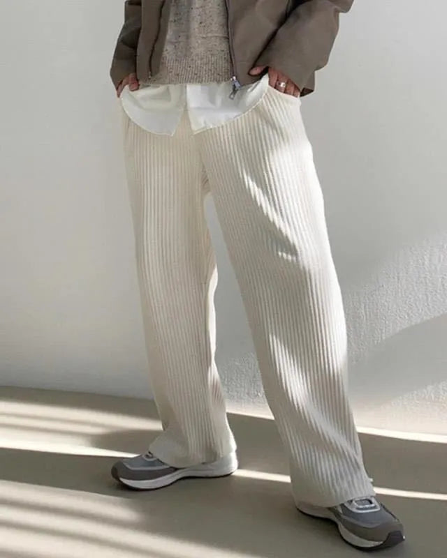 Men's loose corduroy casual pants in solid colour with high waist, drawstring no-fly closure and ankle-tied cuffs.