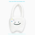 White plush tote bag with cute tooth graphic and a crossbody strap.