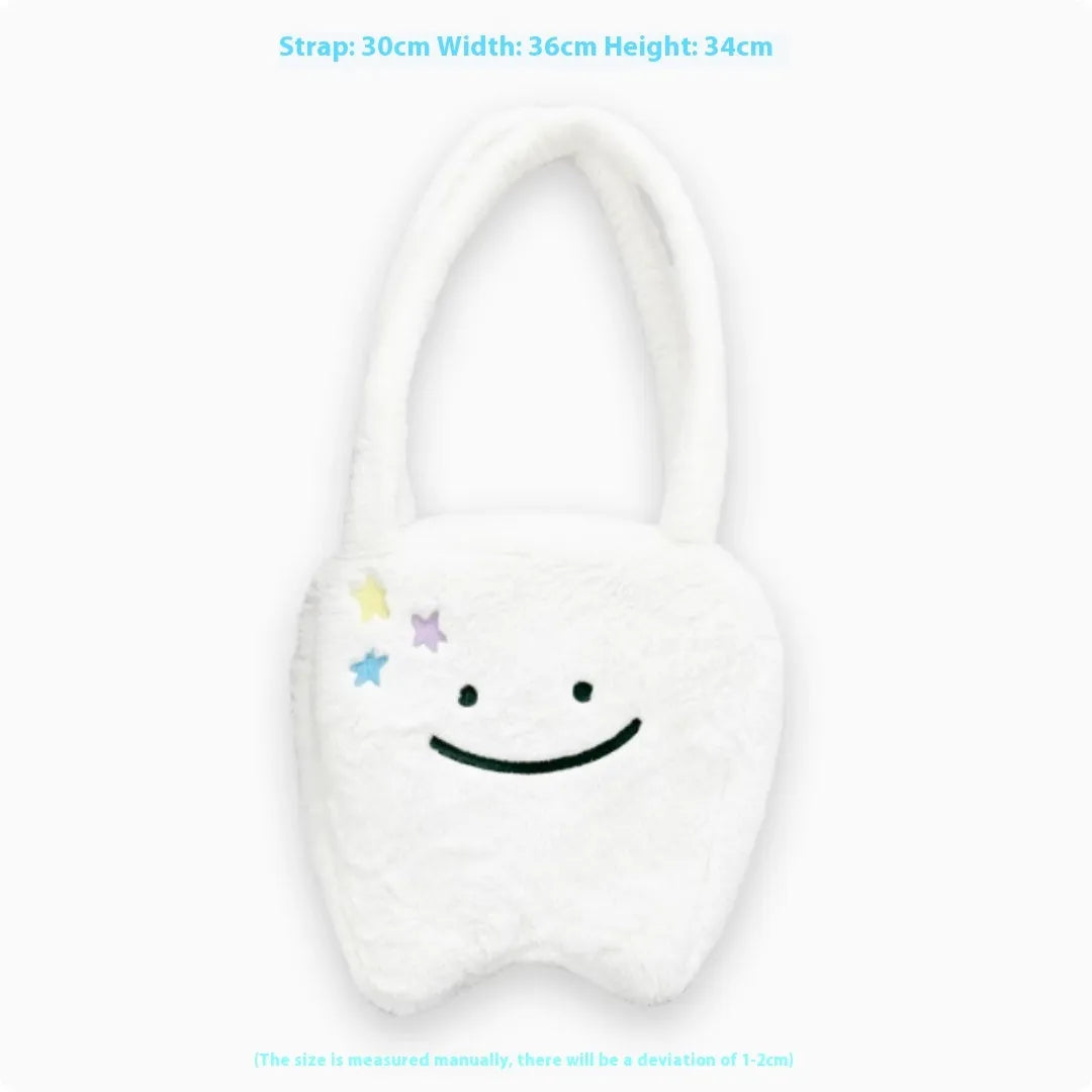 White plush tote bag with cute tooth graphic and a crossbody strap.