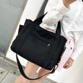 Horizontal square canvas tote bag with side zipper compartments and internal organisation pockets
