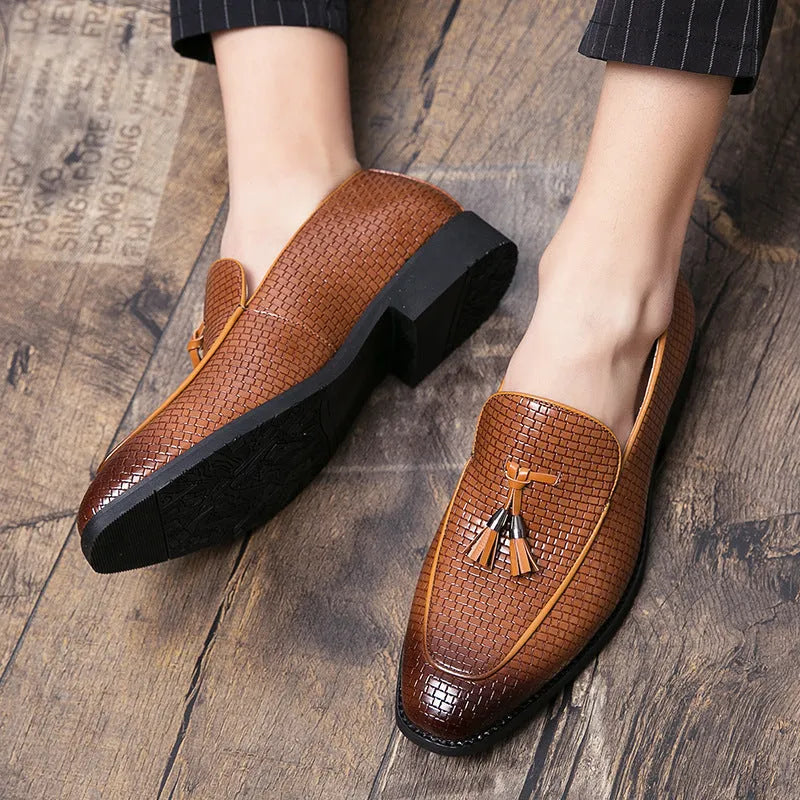 Men's black pointed slip-on leather shoes with tassel detailing on a low-top upper for business wear