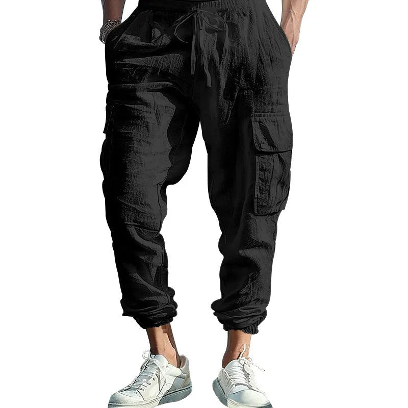 Men's loose-fit linen trousers with ankle ties and multiple pockets in solid colours