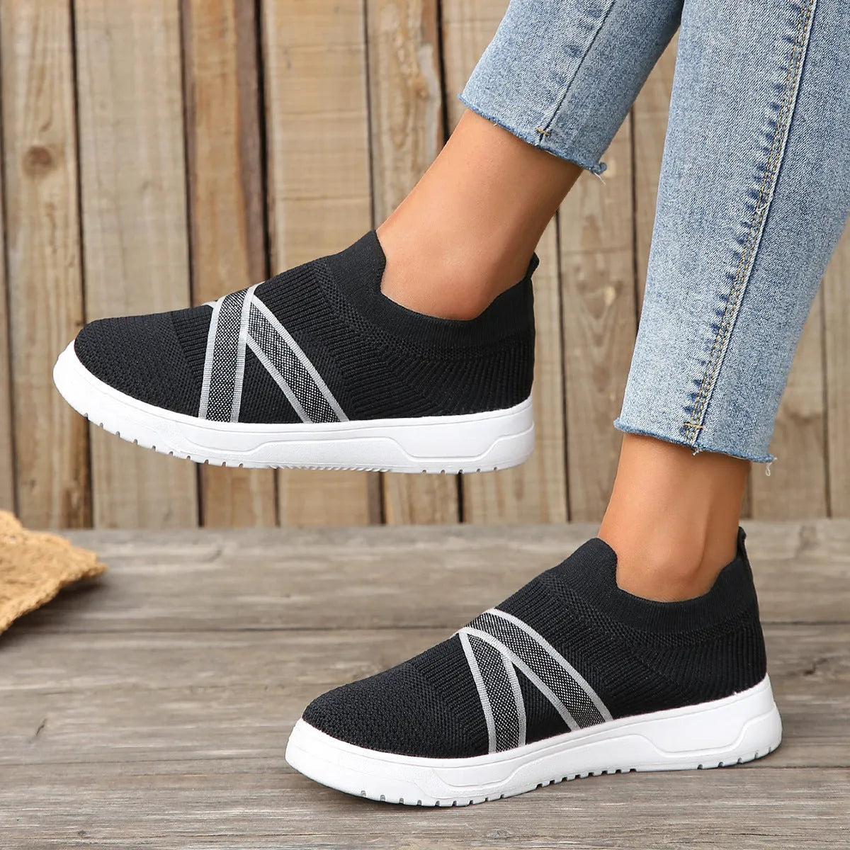 Women's black flyknit mesh casual shoes with flat rubber sole and tassel detail