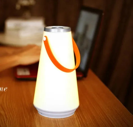 White rechargeable LED bedside table lamp with a compact ABS plastic body and soft warm white glow.