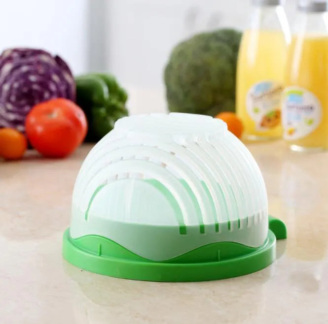 Blue BPA-free plastic salad cutter bowl with cutting grid lid on a white base with raised edges.