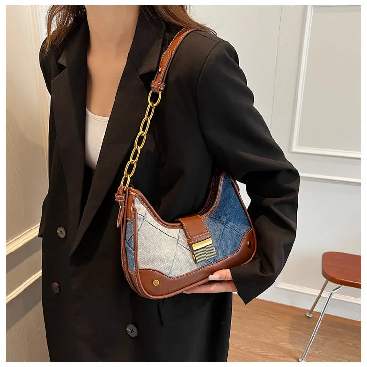 Brown denim women's bucket shoulder bag with diamond mesh detail, chain accents, and double adjustable straps