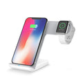 Black wireless phone charger with smartphone positioned on charging surface showing 15W fast charging