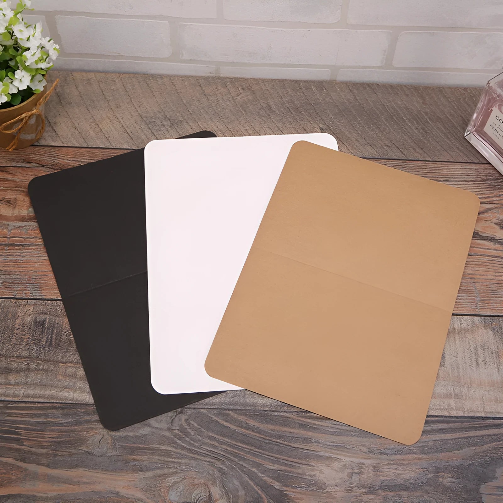 Kraft paper folded greeting cards in black, brown and white showing 10x15cm size