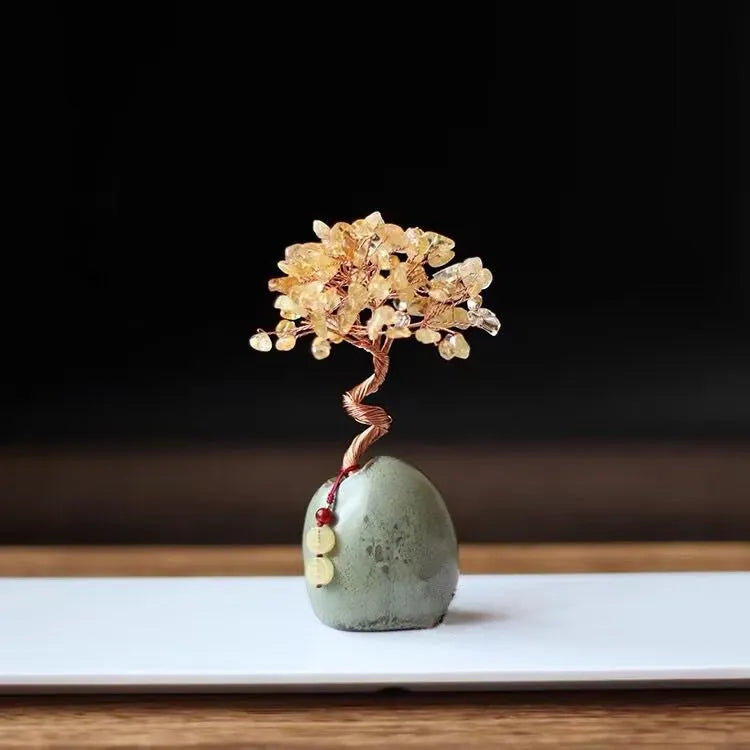 Natural citrine crystal Pachira Macrocarpa lucky ornament on a plain background.