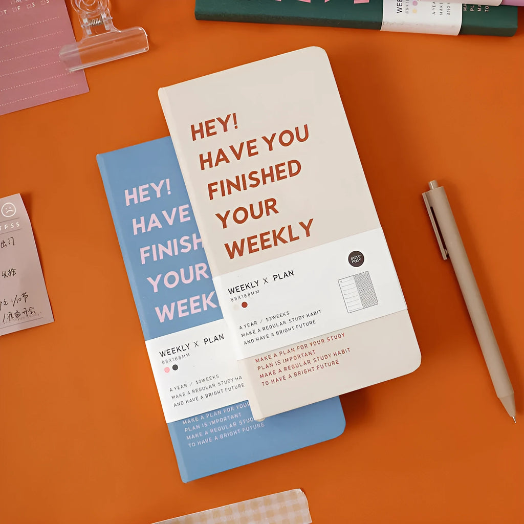 Weekly plan diary handbook in A5 size showing four colour options: blue, brown, green, purple