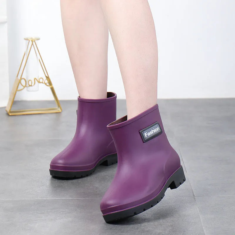 Women's PVC mid-calf rain boots in black, brown, apricot, and purple colours