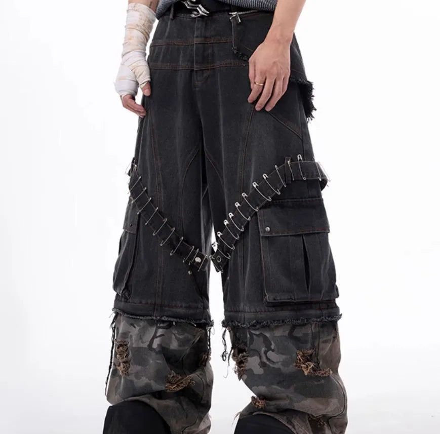 Men's grey jeans with camouflage pattern splicing and pin ribbon details on the legs.