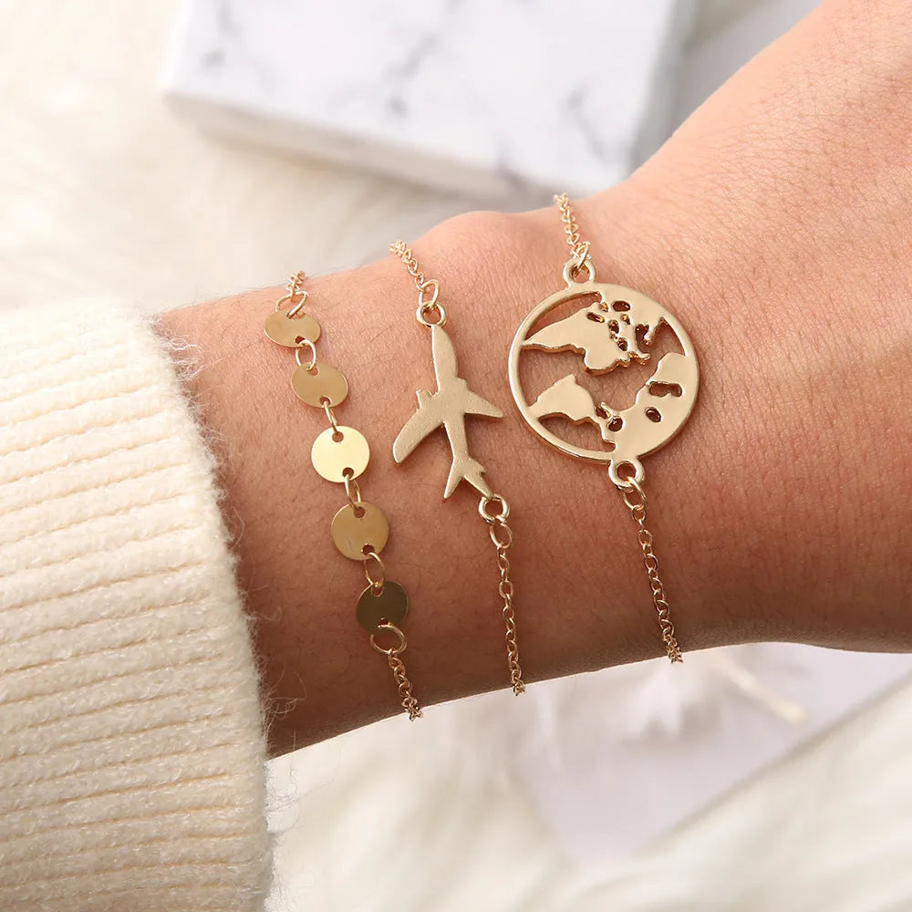 Three bohemian bracelets with heart-shaped alloy charms showing aircraft map designs in sku2104 colour.