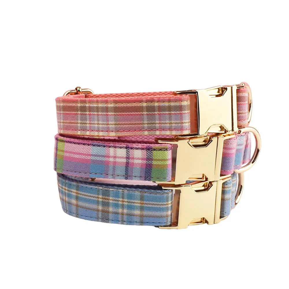 Sky blue and white grid pattern dog collar, leash, bow, and vest four-piece pet accessory set.