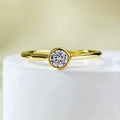 Minimalist silver crown ring with linear design details in R962 gold or platinum finish on a grey background.