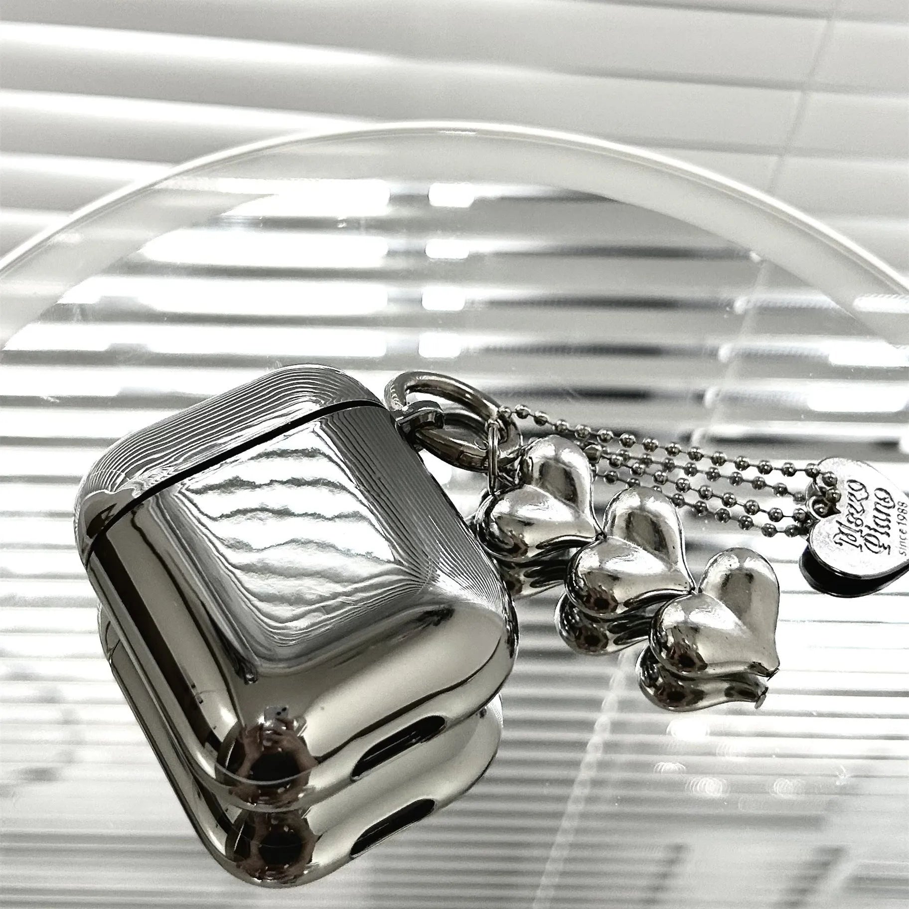 Electroplated TPU headphone case with heart pendant and bracelet chain decorative elements