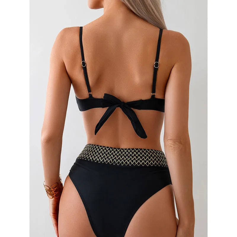 Black women's bikini swimsuit set with sleeveless top and briefs on a neutral background.