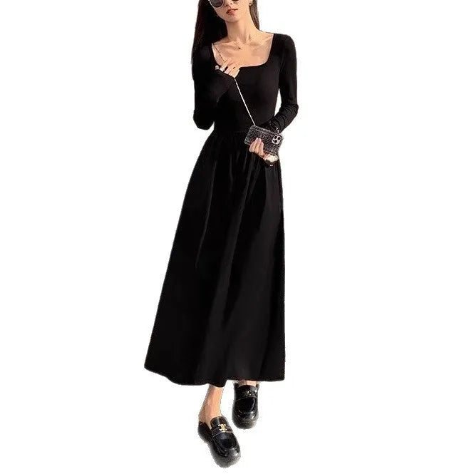 Women's black square collar knitted dress with elastic waist and long A-line skirt, made from polyester fabric.
