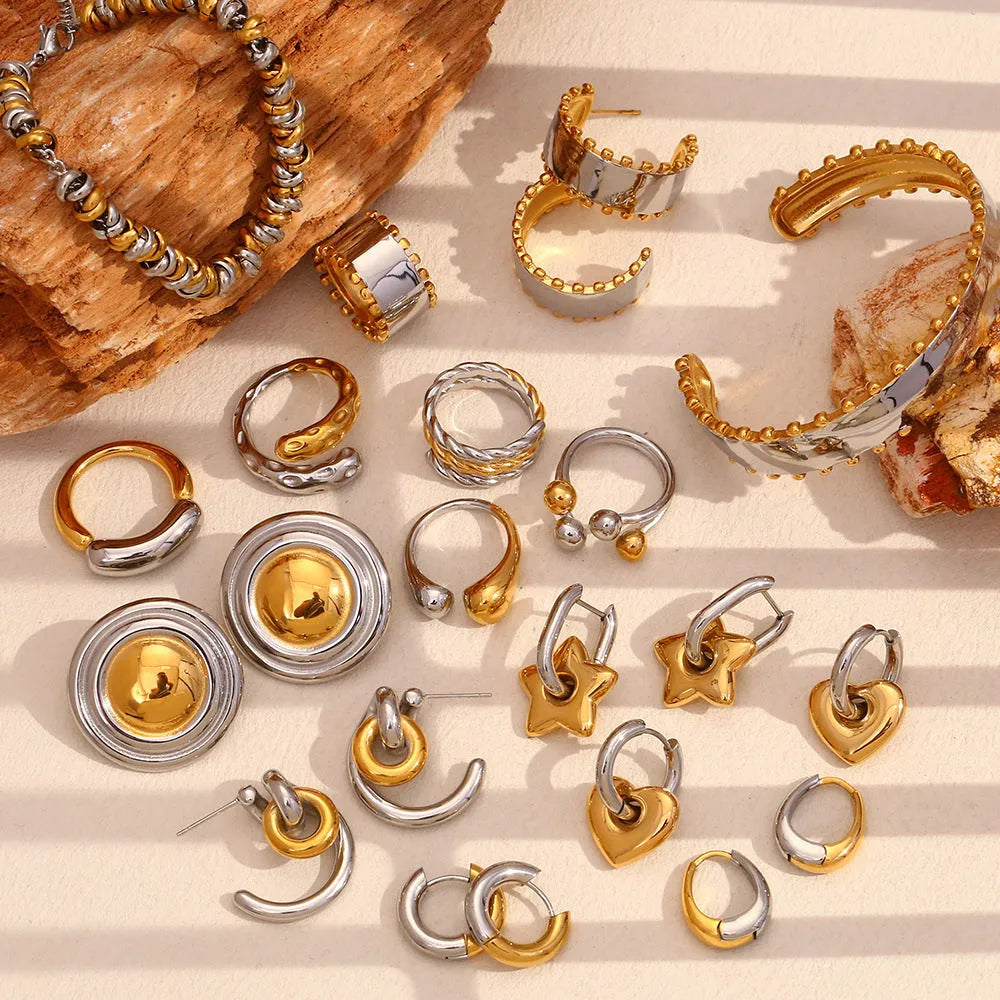Electroplated gold jewellery set with geometric shapes and round ring elements including earrings, bracelet, and necklace