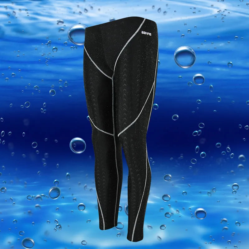 Men's black and green line nylon cropped swimming trunks on a white background.