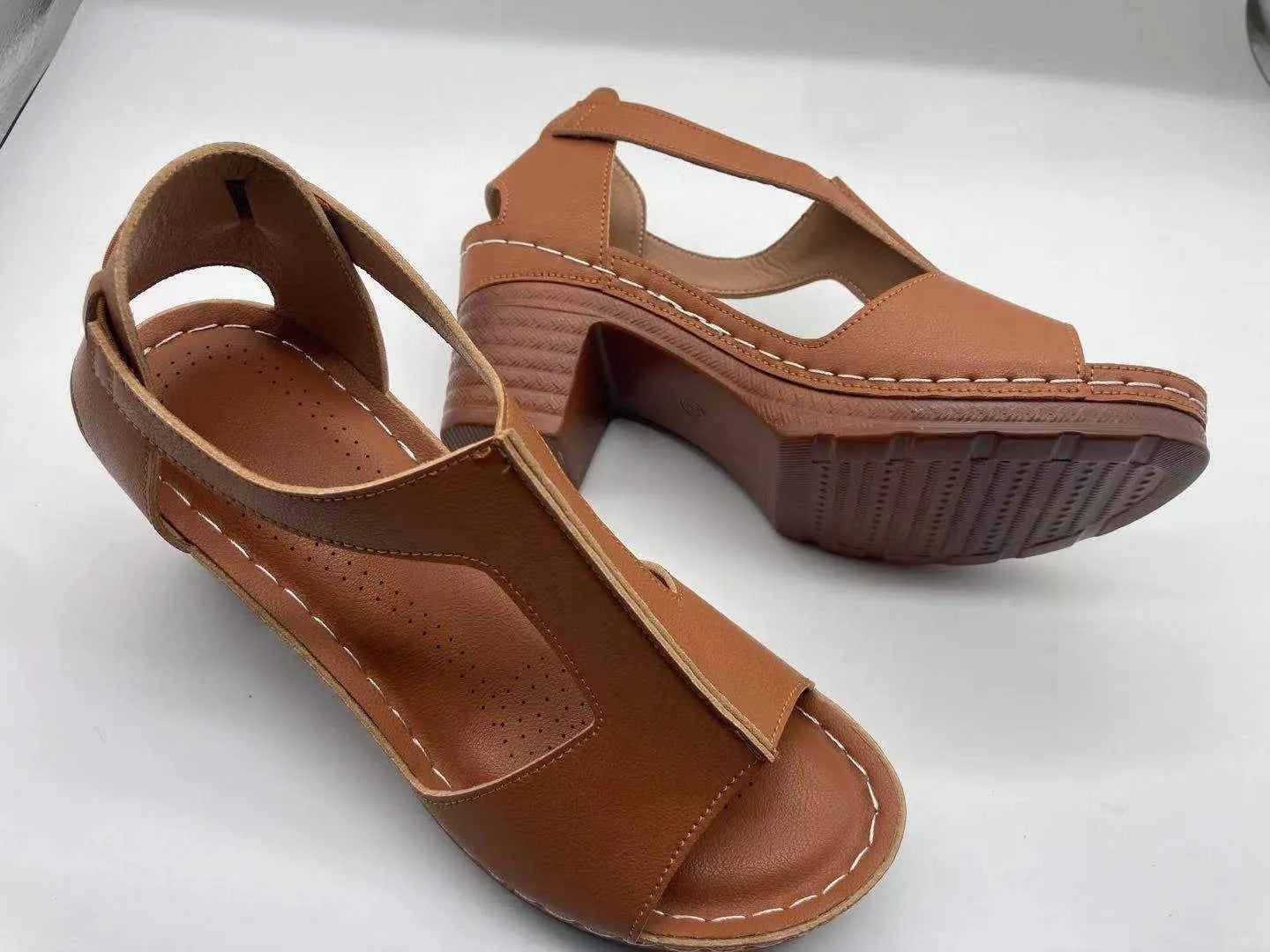 Women's plus size peep toe wedge sandals with a buckle strap in a light brown colour.