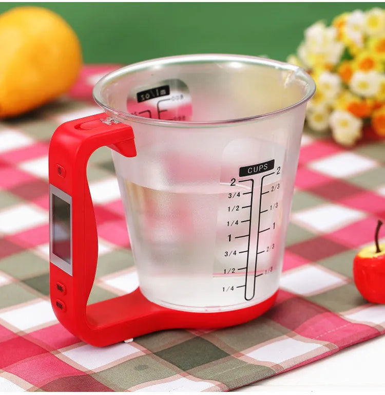 Green electronic scale measuring cup with integrated LCD display showing weight and temperature readings