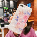 Soft TPU iPhone case with a rose flower design on the back, shown in brown.