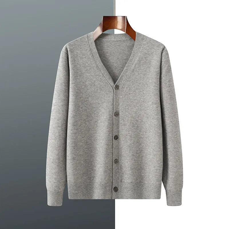 Man wearing a loose beige Andy velvet V-neck cardigan coat with long sleeves.
