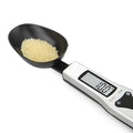 Digital measuring spoon with LCD display showing weight measurement