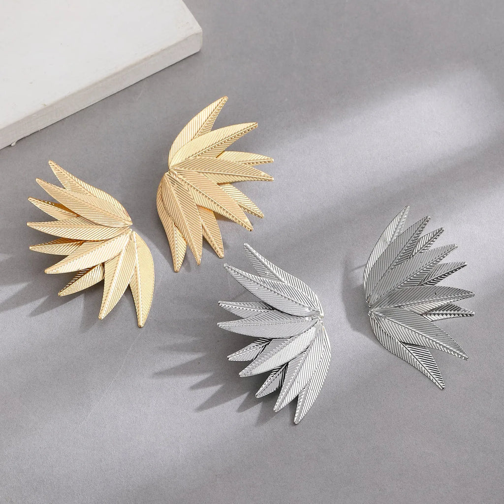 Gold and white alloy leaf-shaped stud earrings with botanical design