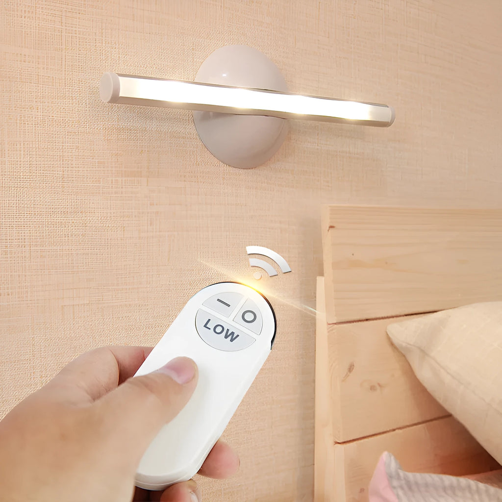 White LED portable night light with a remote control on a wooden surface.