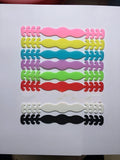Set of eight small silicone tool buckles in various colours including red, yellow, black, and blue.