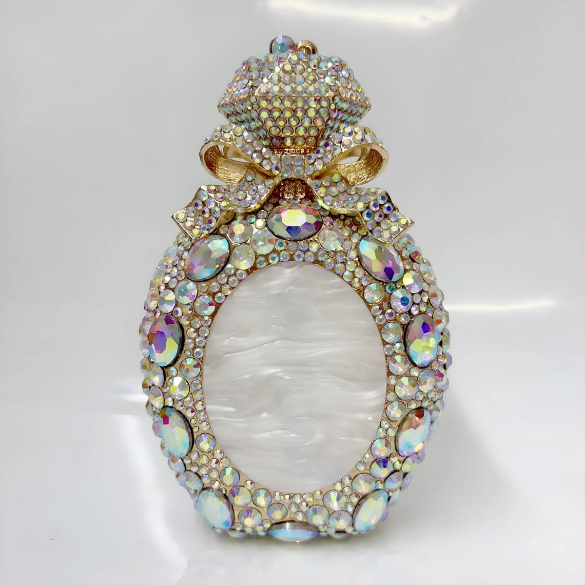 Women's hard alloy clutch bag with full diamond coverage in a golden colour.